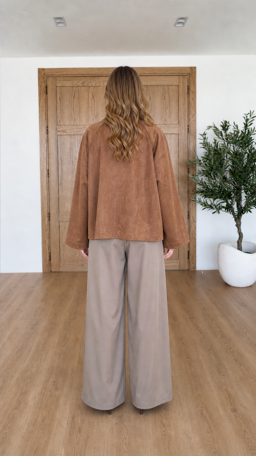 Back view of woman wearing relaxed Camel faux suede wrap jacket