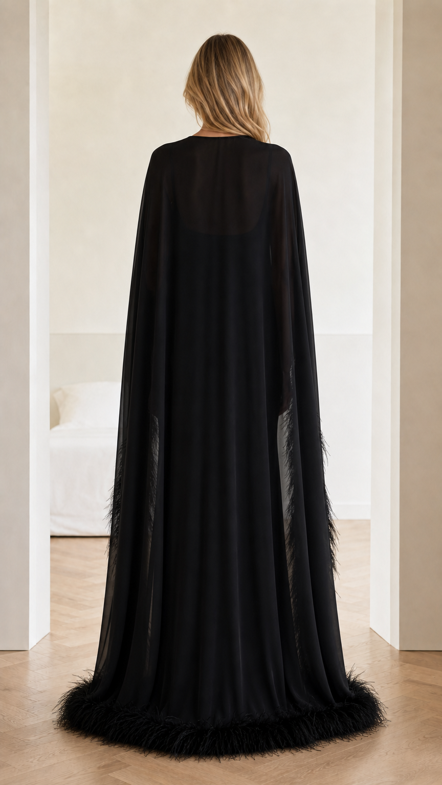 Back view of floor-length black sheer cape evening gown