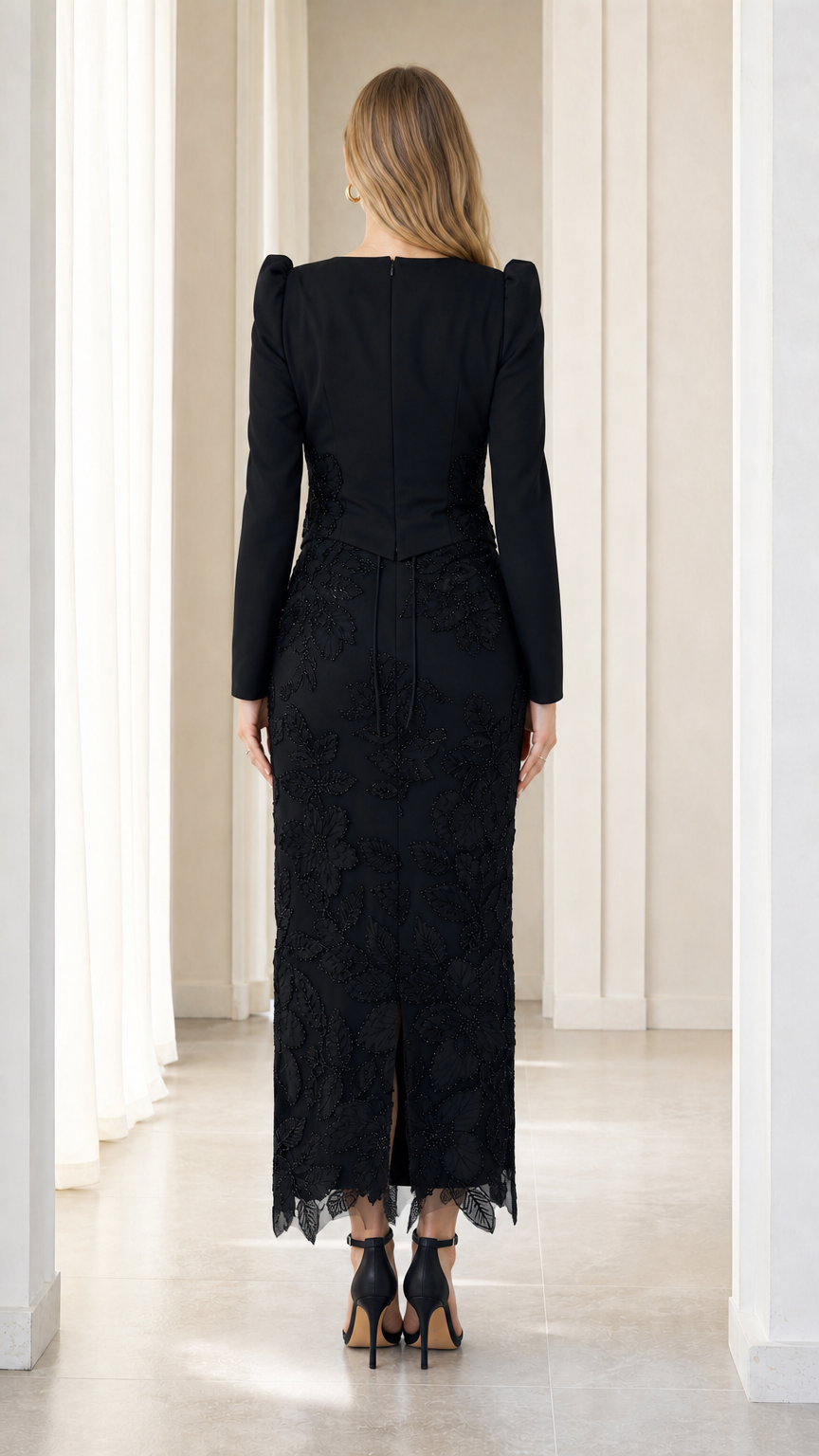 Back view of black column evening gown showing back slit and smooth fit