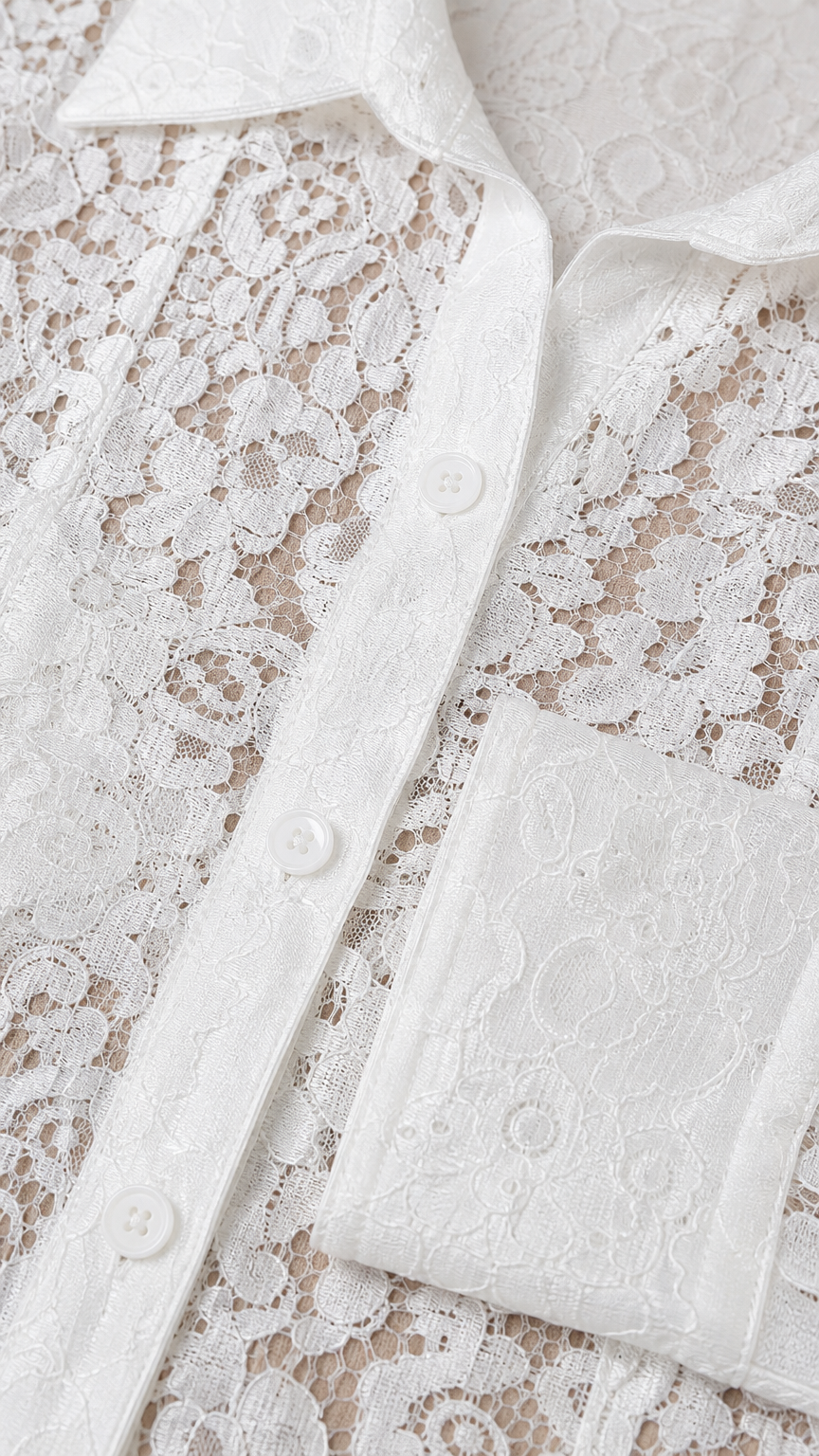 Close-up detail of white floral lace fabric and button placket