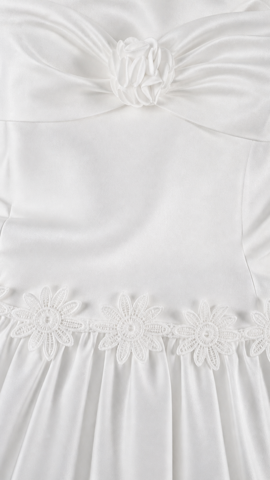 Close-up of floral bodice detail and embroidered skirt seam on white set