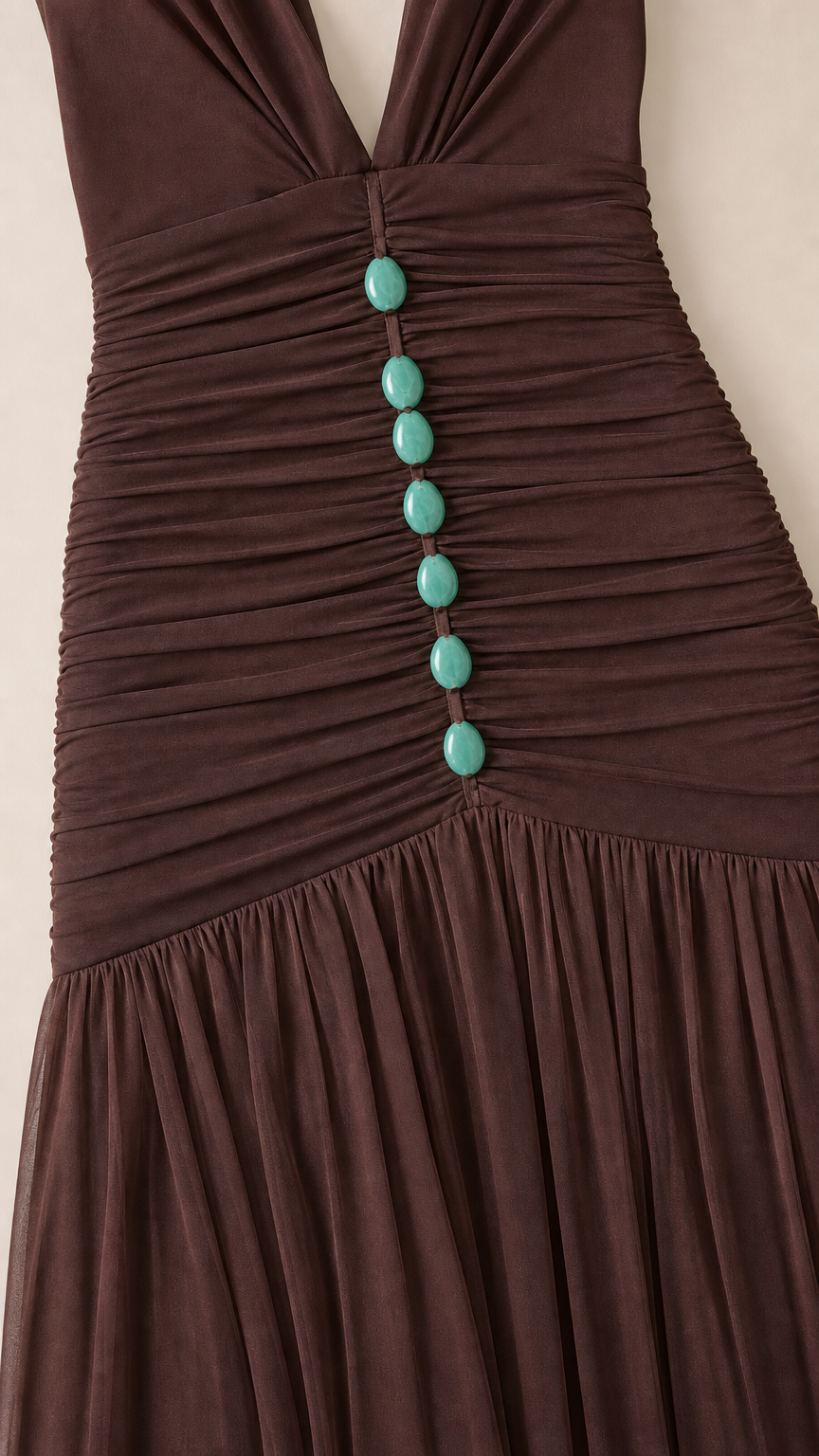 Close-up detail of bodice ruching and buttons on brown dress