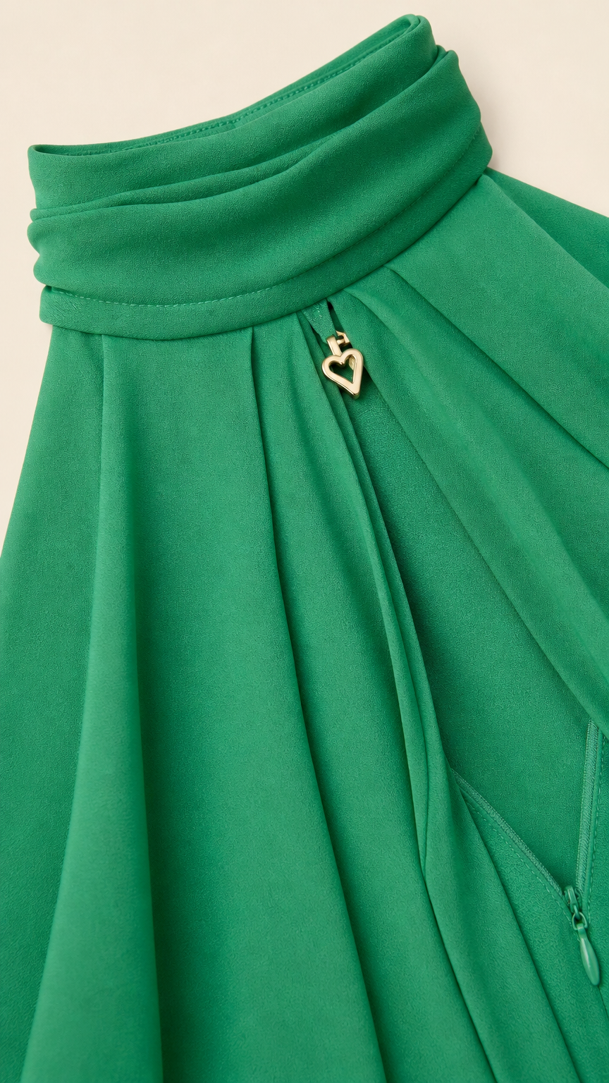 Close up of neckline detail with gold heart charm on green dress