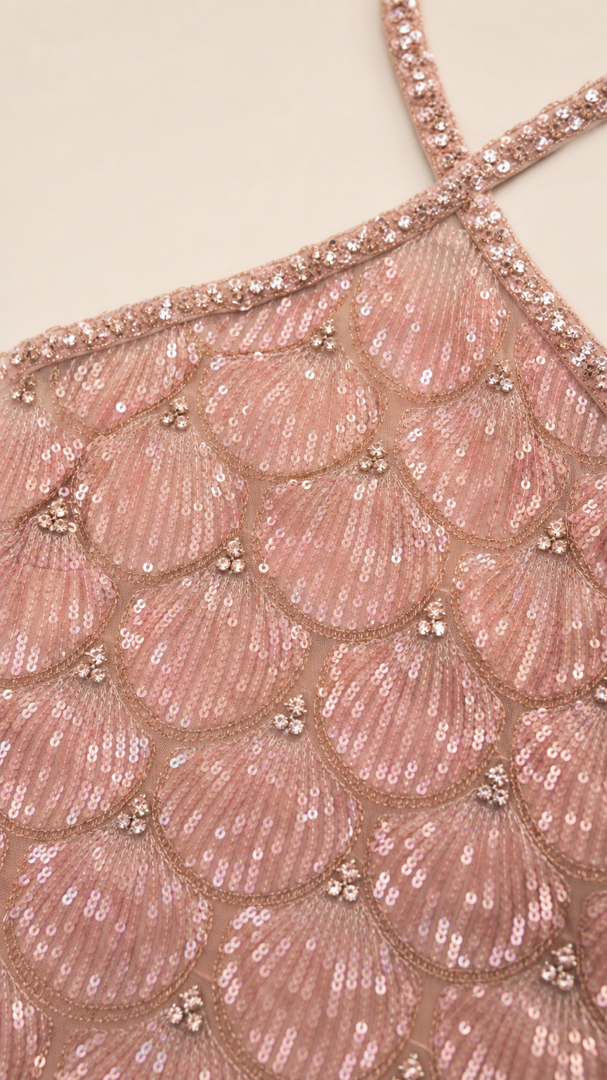 Close-up detail of scalloped sequin pattern and beaded halter strap