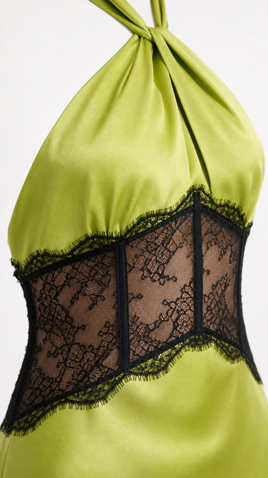 Close-up detail of sheer black eyelash lace corset midriff on lime green satin
