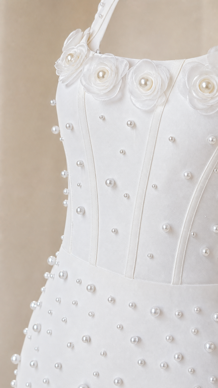Close up of 3D rosette and pearl bodice details on white dress