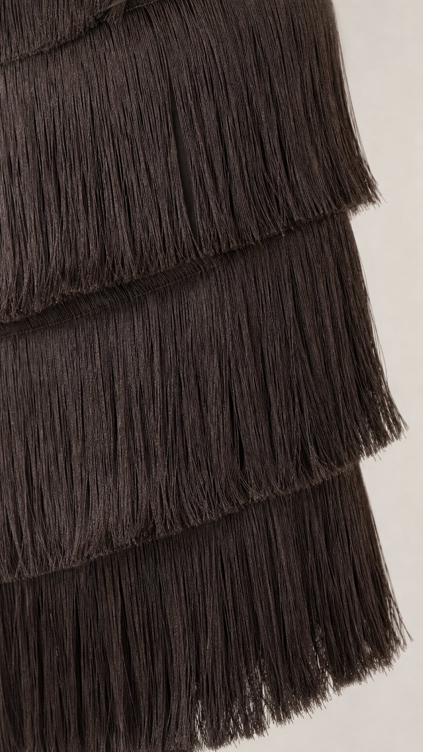 Close up detail of dark brown layered fringe texture