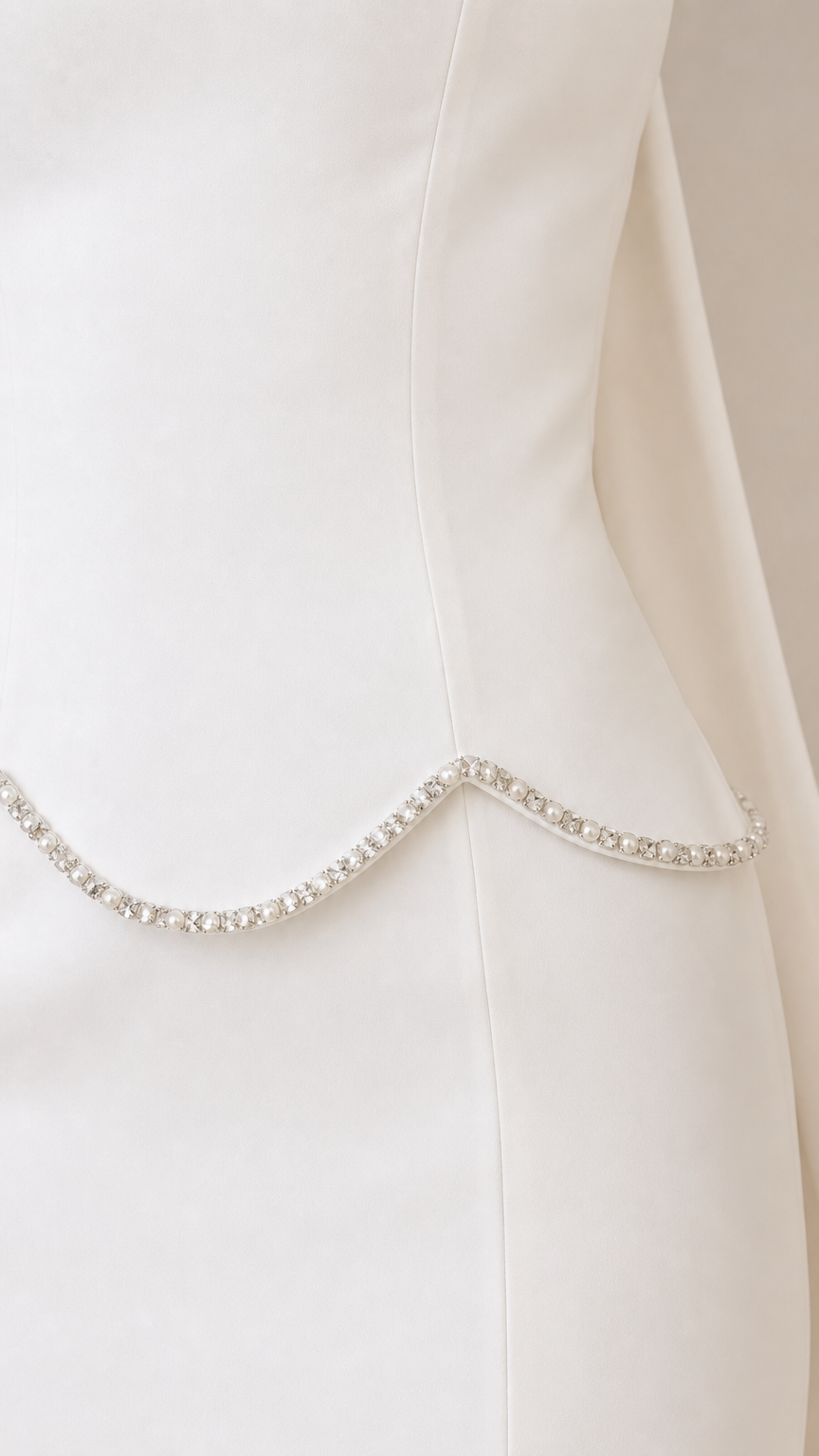 Close-up of sparkling rhinestone trim along the scalloped waistline