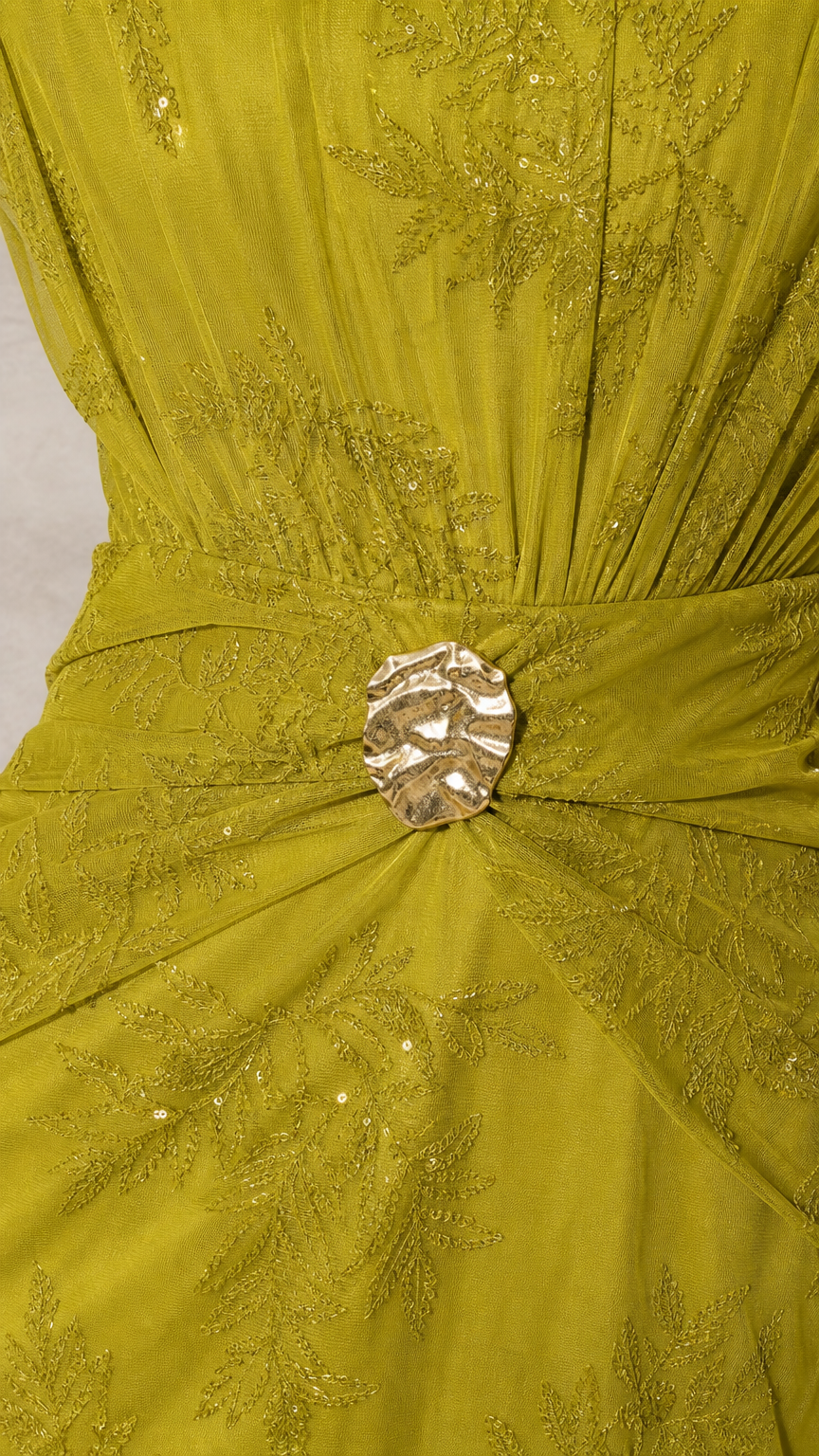 Close-up of gold buckle and embroidery detail