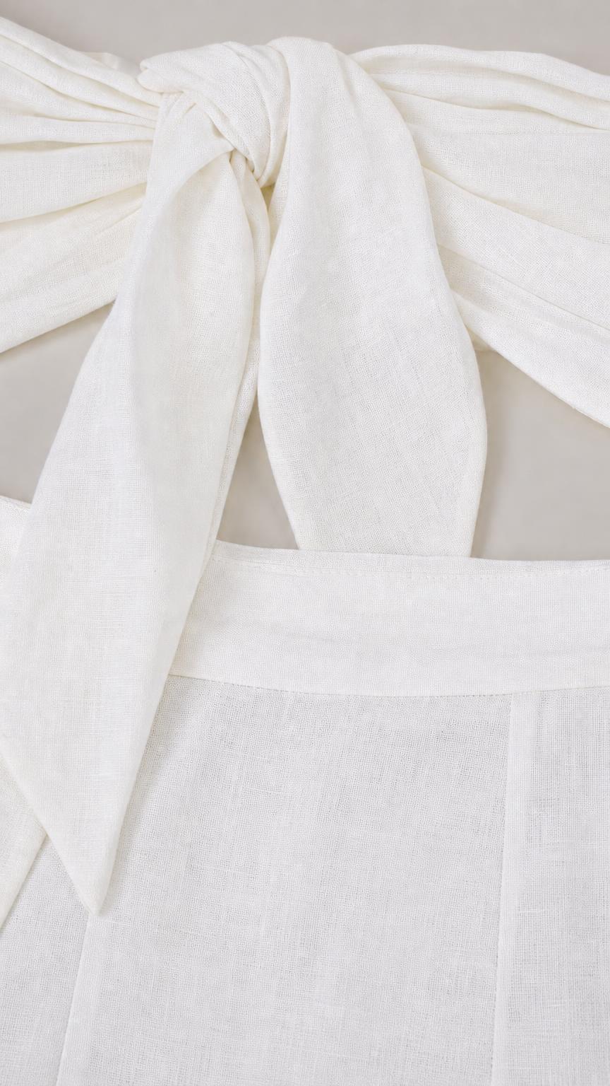 Close-up of fabric texture and front knot detail on white top