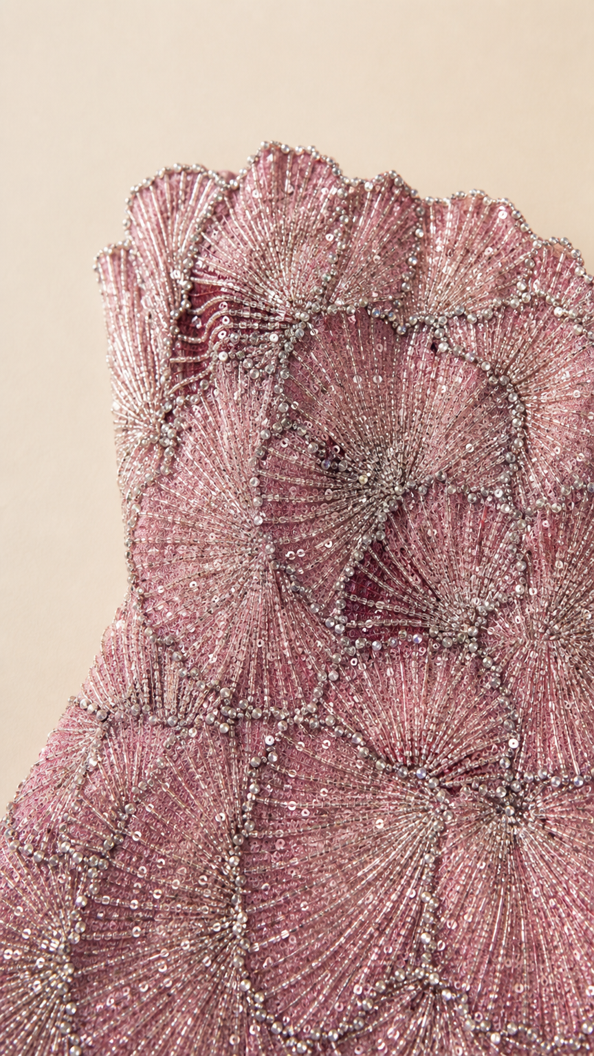 Close-up detail shot of intricate beadwork and scalloped bodice