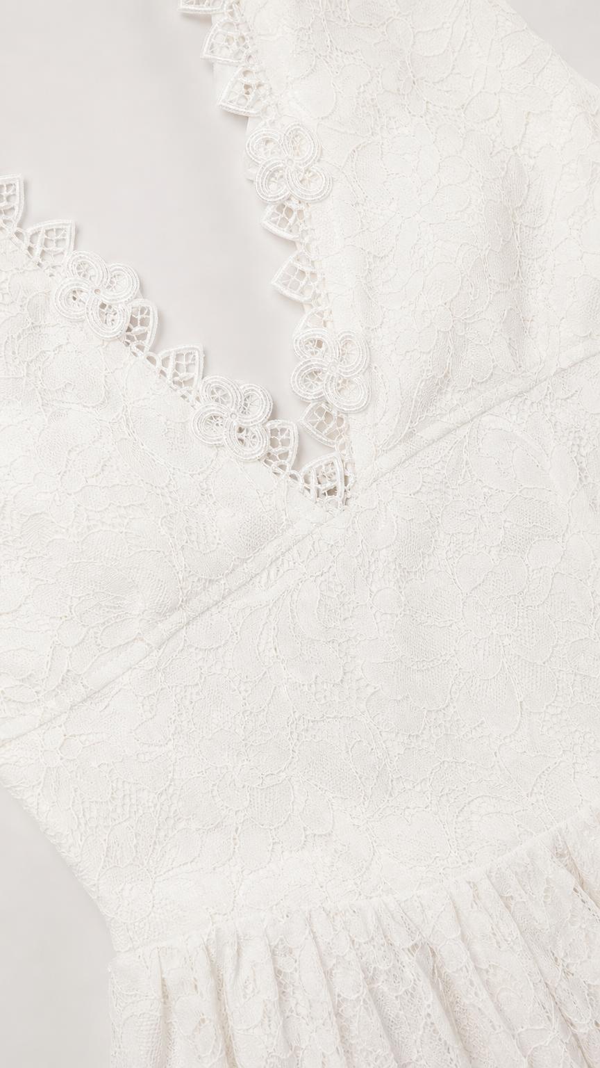 Close-up detail of V-neckline scalloped lace trim