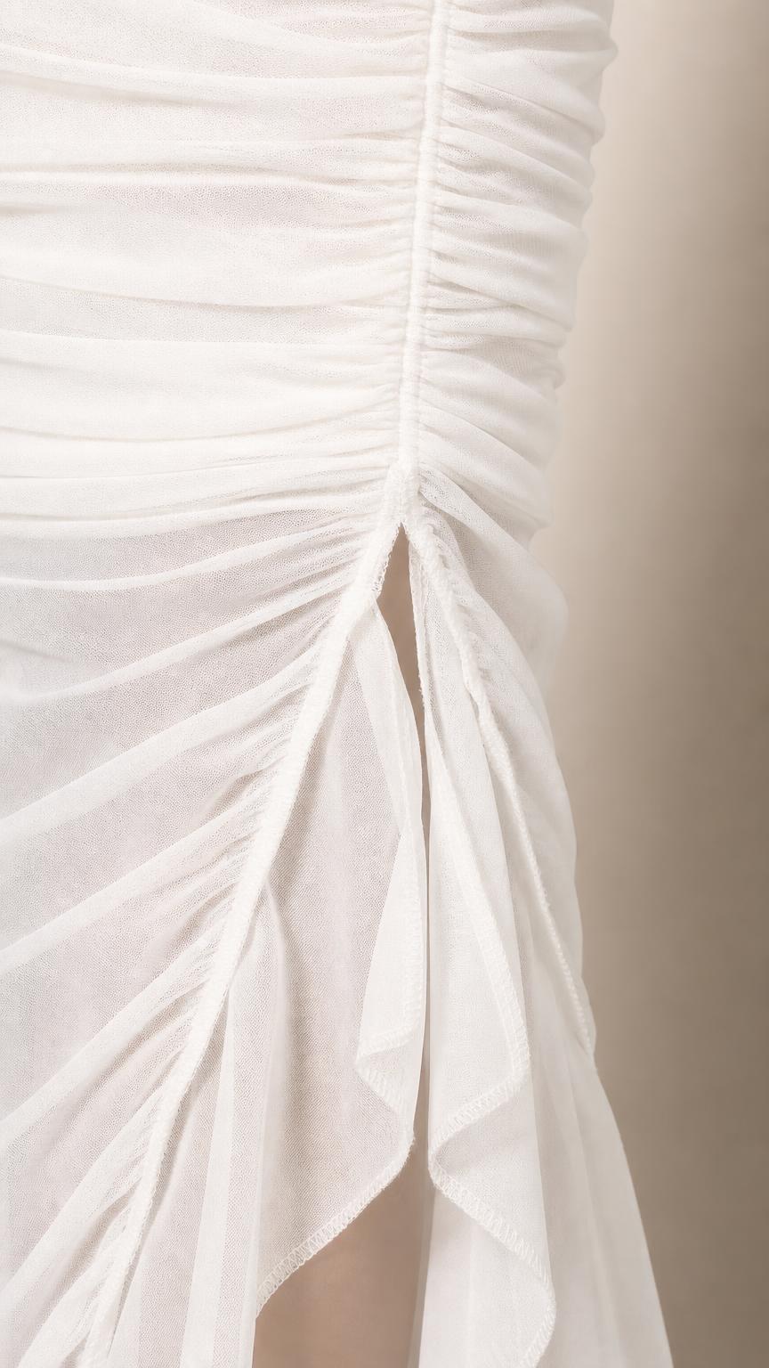 Close-up detail of side slit and mesh ruching on White dress