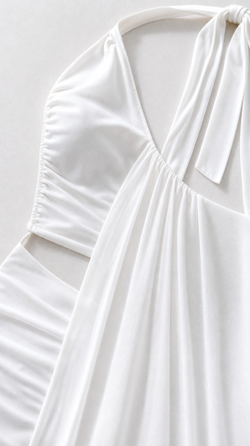Close-up detail of white fabric, bodice, and cutout construction