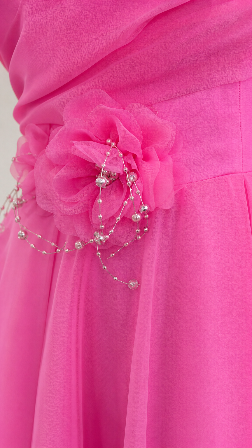 Close-up detail of 3D fabric flower appliqué and delicate beadwork
