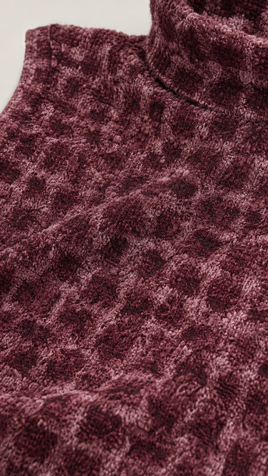 Close-up of fabric texture and mock neck detail in burgundy