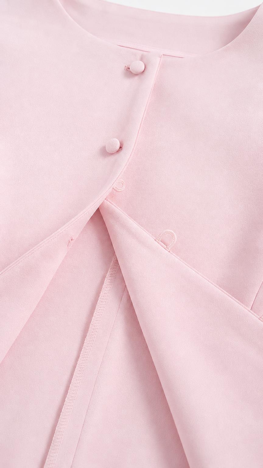 Close-up of pink top buttons and fabric detail