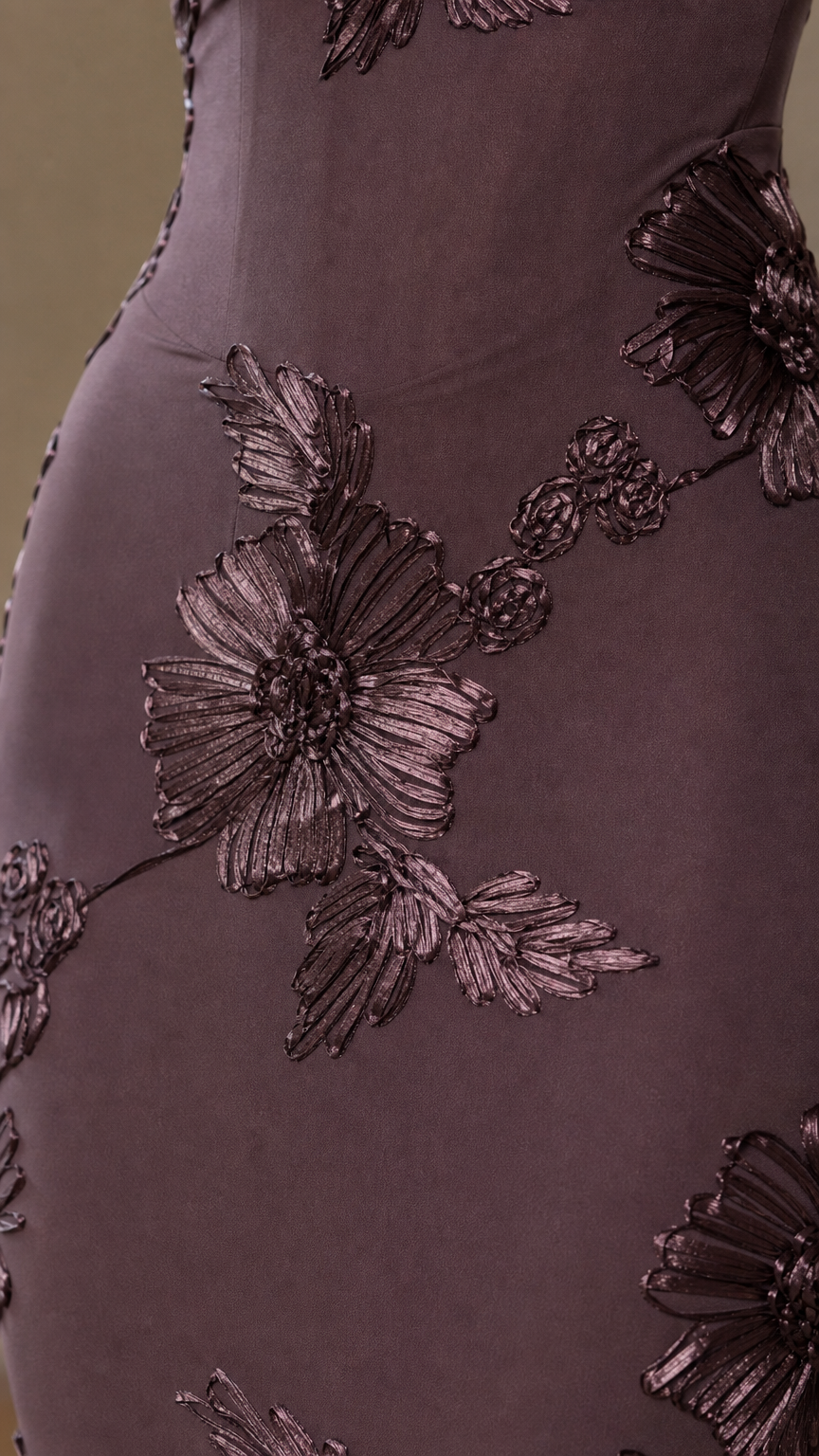 Close-up of dimensional floral embroidery on burgundy dress