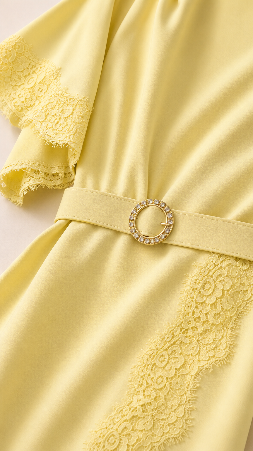 Close-up of flutter sleeve and belt detail on yellow dress