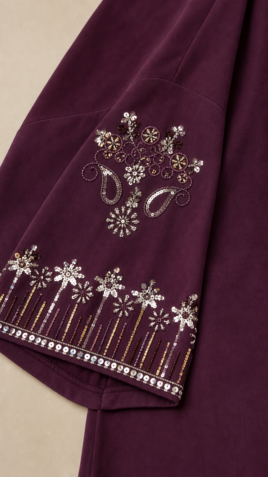 Close-up of intricate metallic thread and sequin embroidery on sleeve cuff
