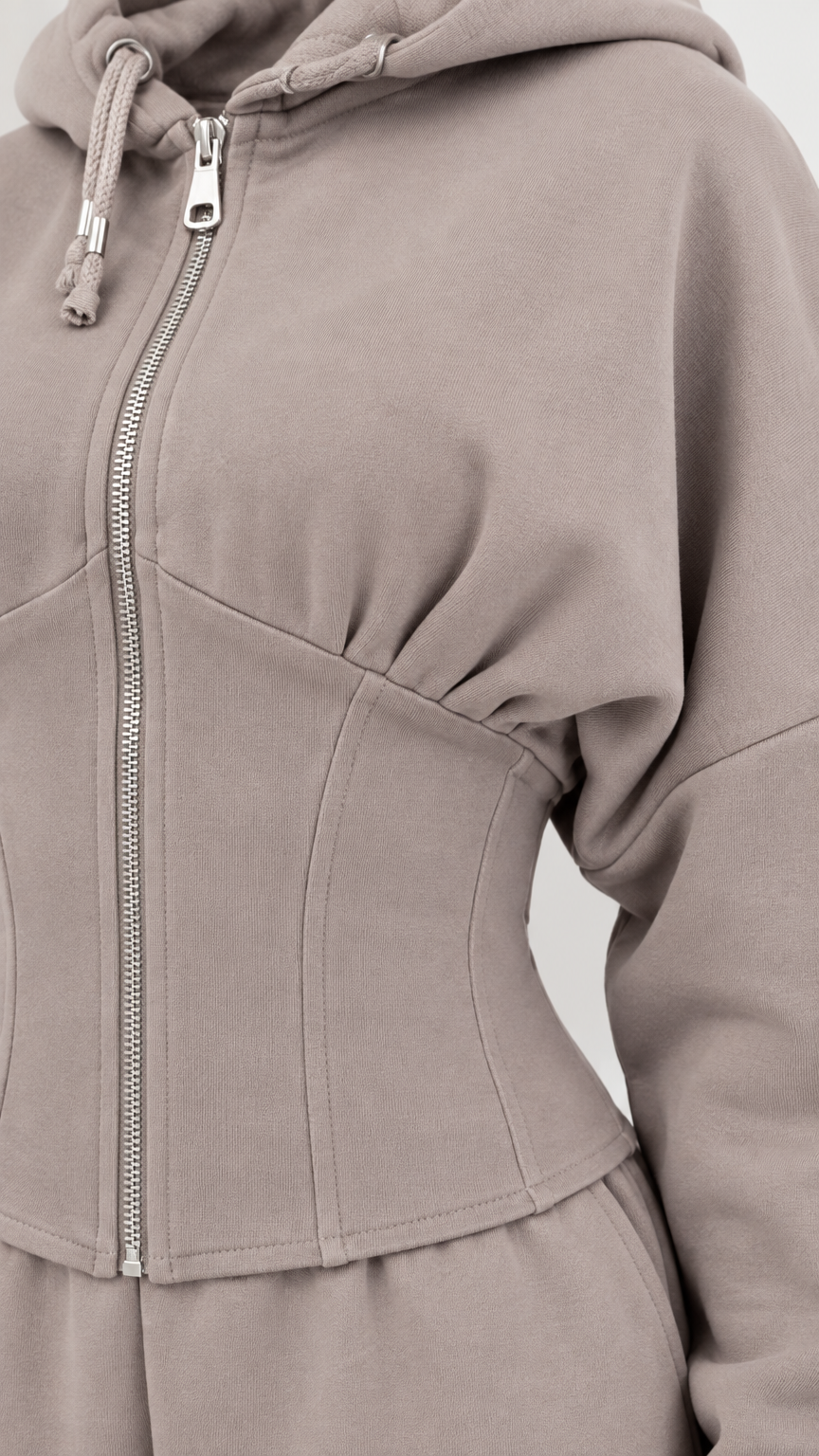 Close-up detail of taupe corset seaming and front zipper on hoodie
