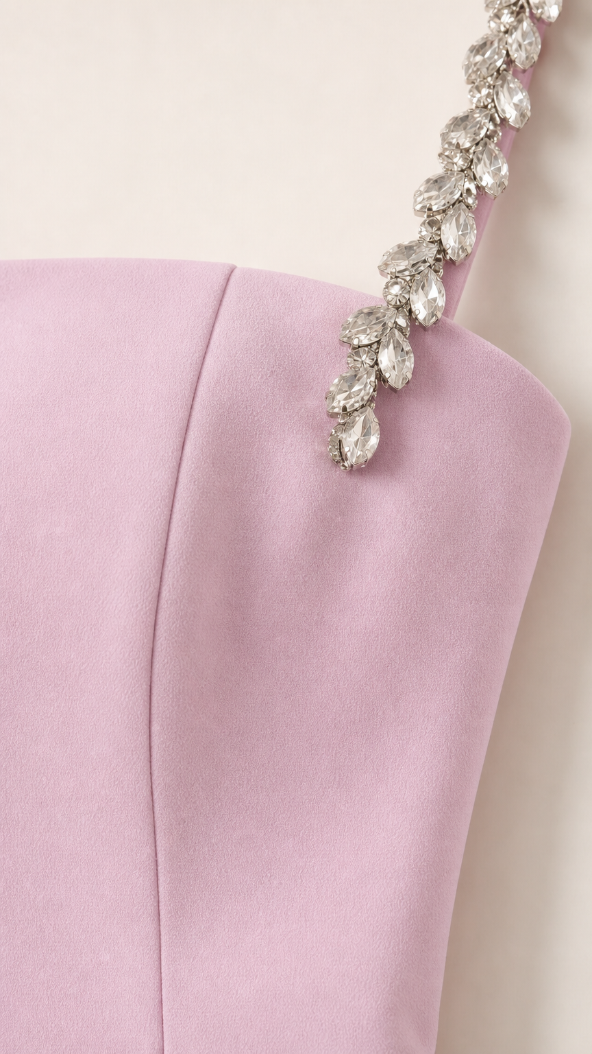 Close-up detail of crystal rhinestone embellishments on dress shoulder strap