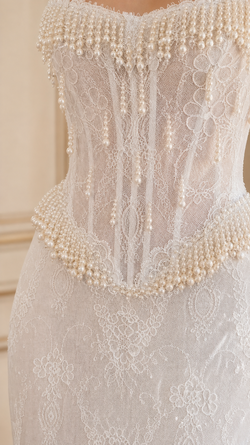 Close-up detail of white corset bodice featuring boning and pearl bead fringe
