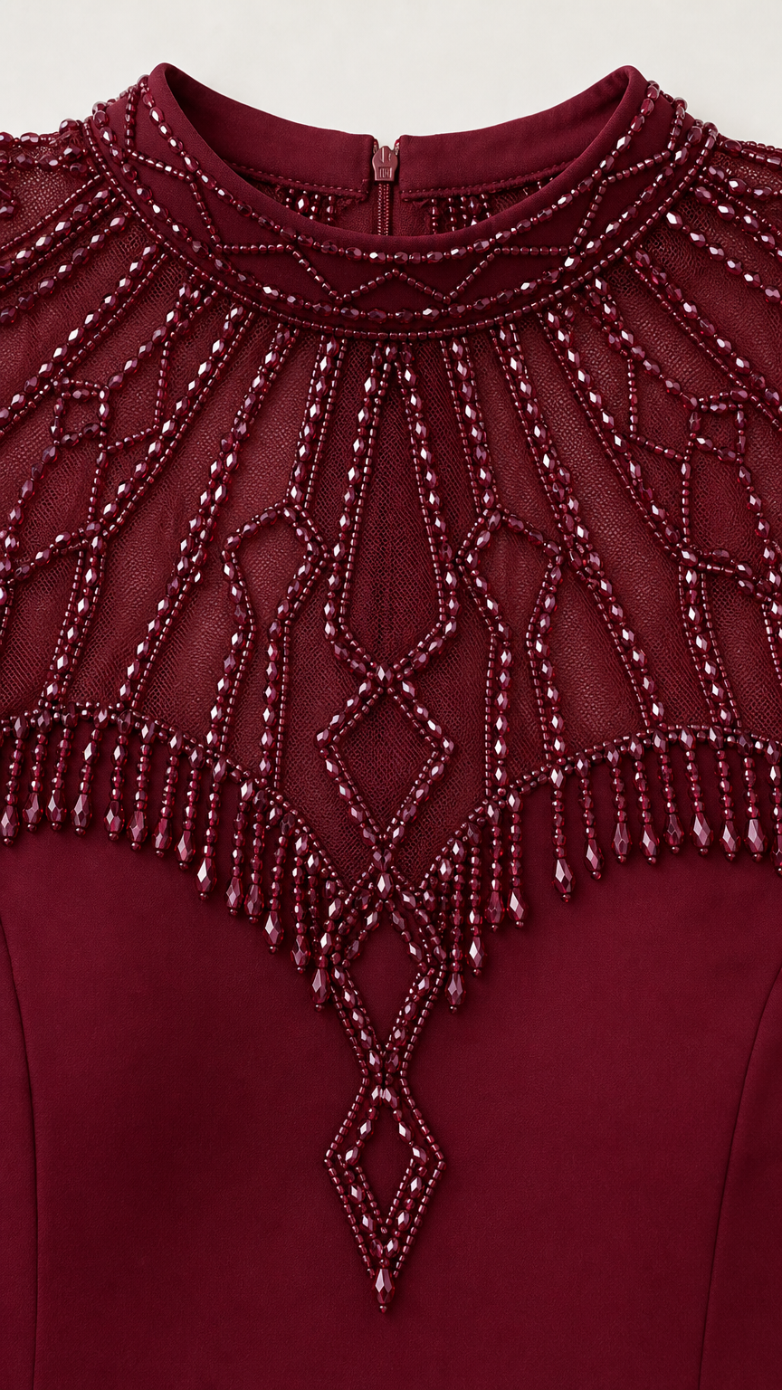 Close-up detail of ornate beadwork and fringe on neckline and cap sleeves
