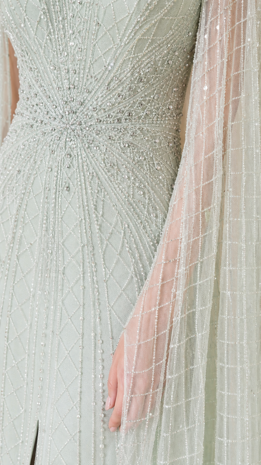 Close-up of beadwork and sheer fabric on sage green gown