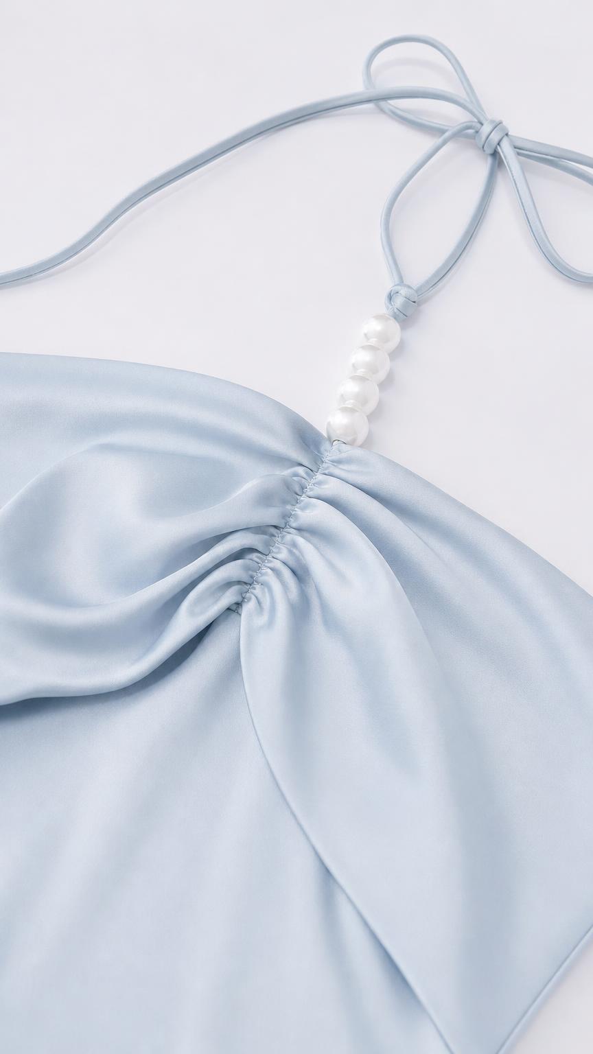 Close-up of halter strap with faux pearl embellishments and ruched bodice
