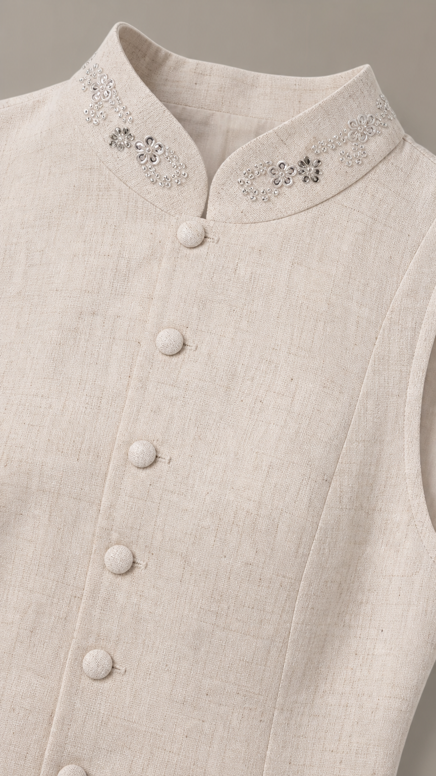 Close-up detail of rhinestone embellished stand collar and buttons