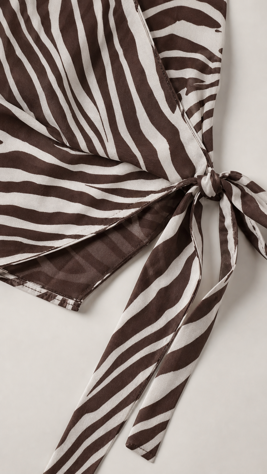 Close-up detail of smooth woven zebra print fabric and tie closure