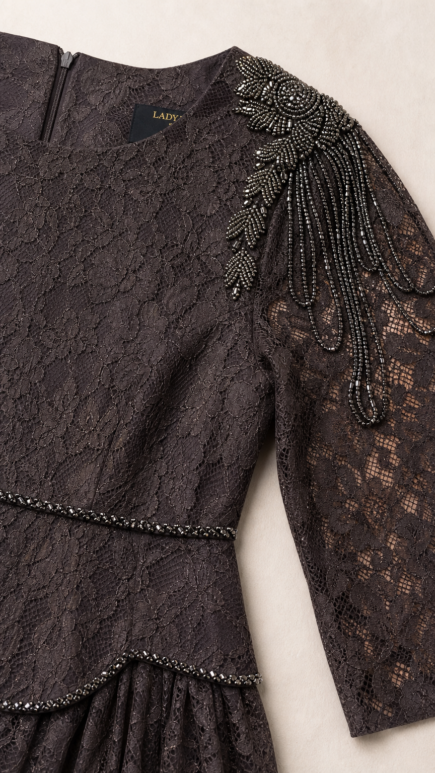Close-up detail of beaded shoulder embellishments and lace texture