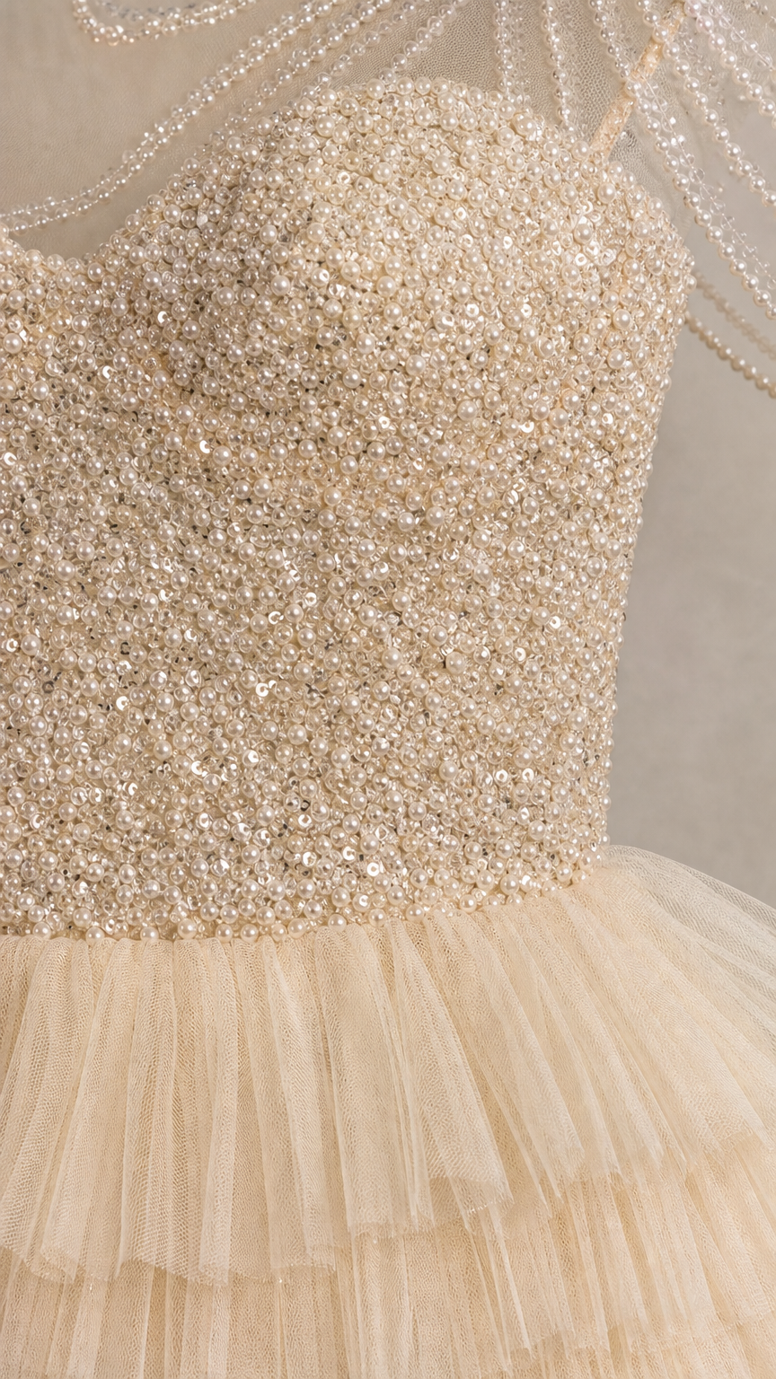 Close-up detail of sequined bodice and beaded sheer neckline