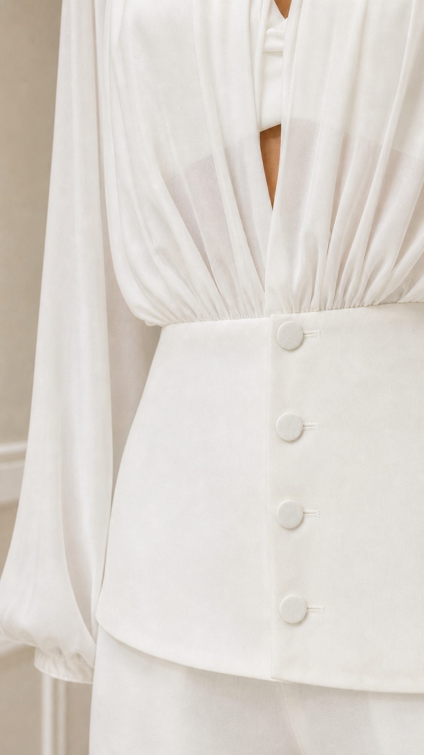 Close up of white blouse button down waist and gathering detail