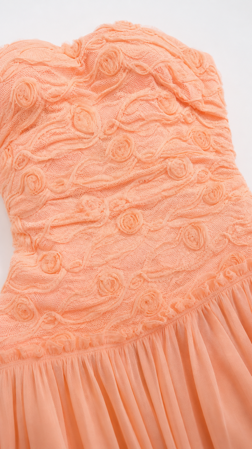 Close up of textured bodice on peach maxi dress