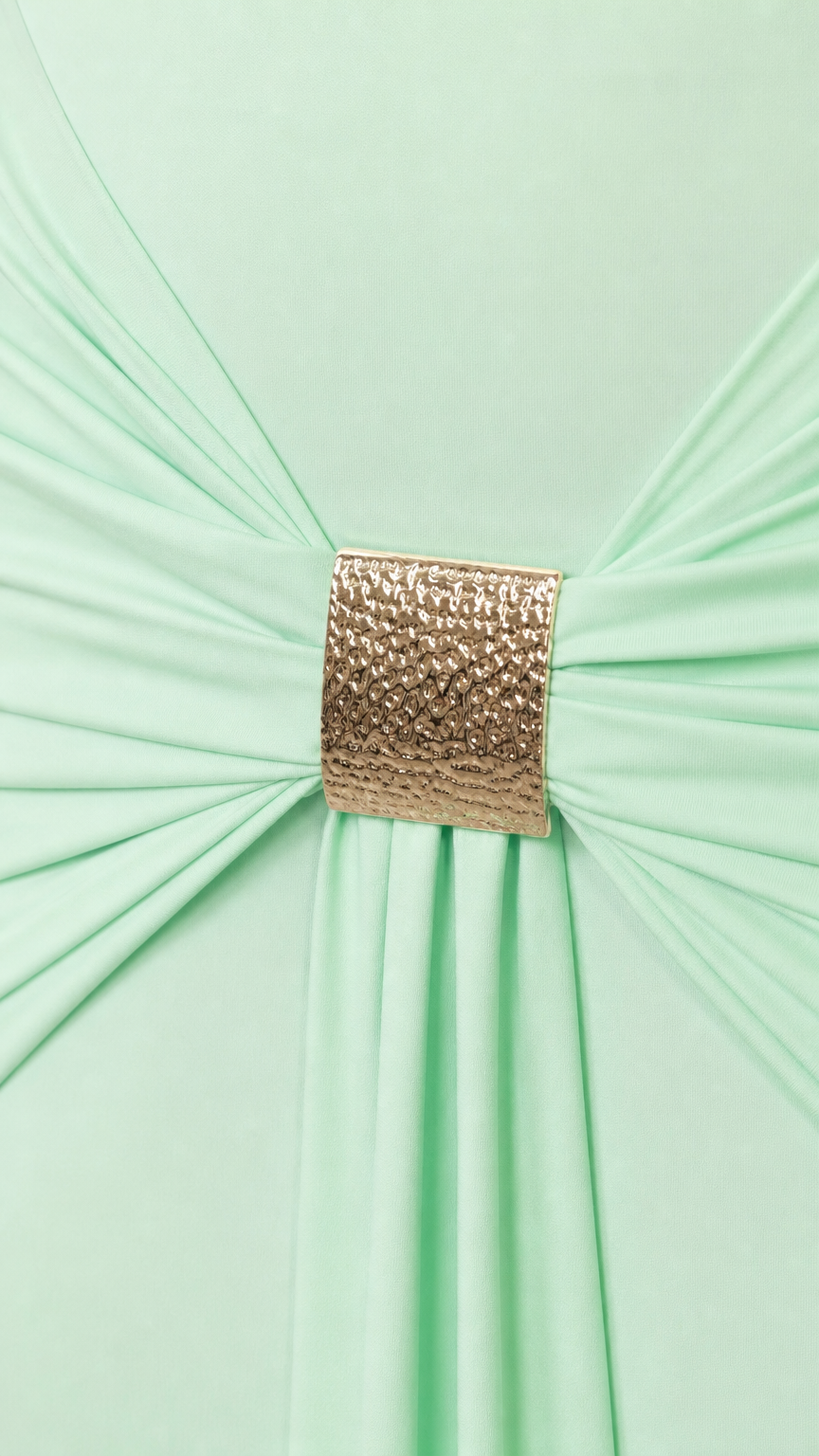 Close-up of gold metallic buckle gathering fabric on the dress