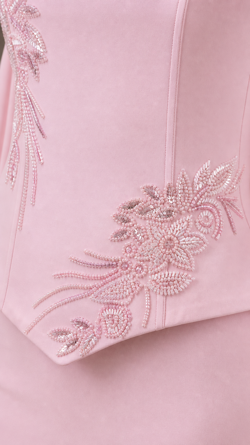 Close-up of delicate tonal floral beadwork and embroidery on bodice hem
