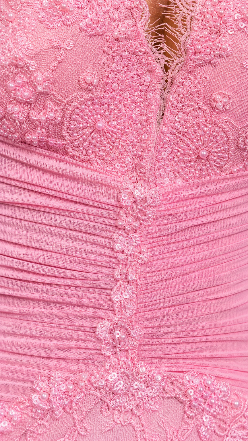 Close-up detail of lace texture and ruched bodice on pink dress