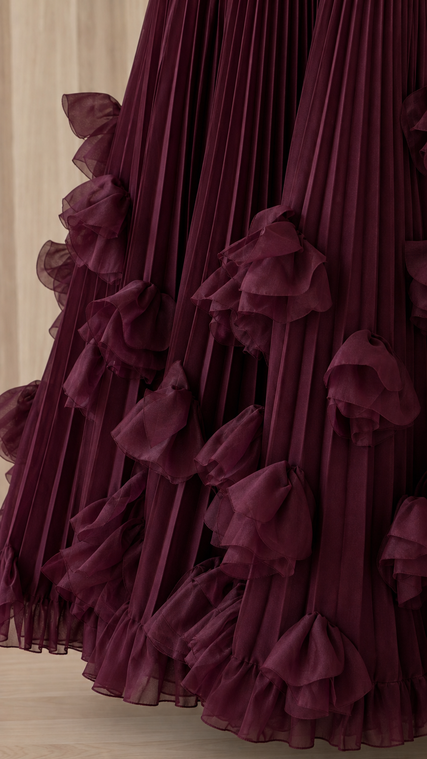 Close-up detail of sheer dimensional ruffles on pleated hem