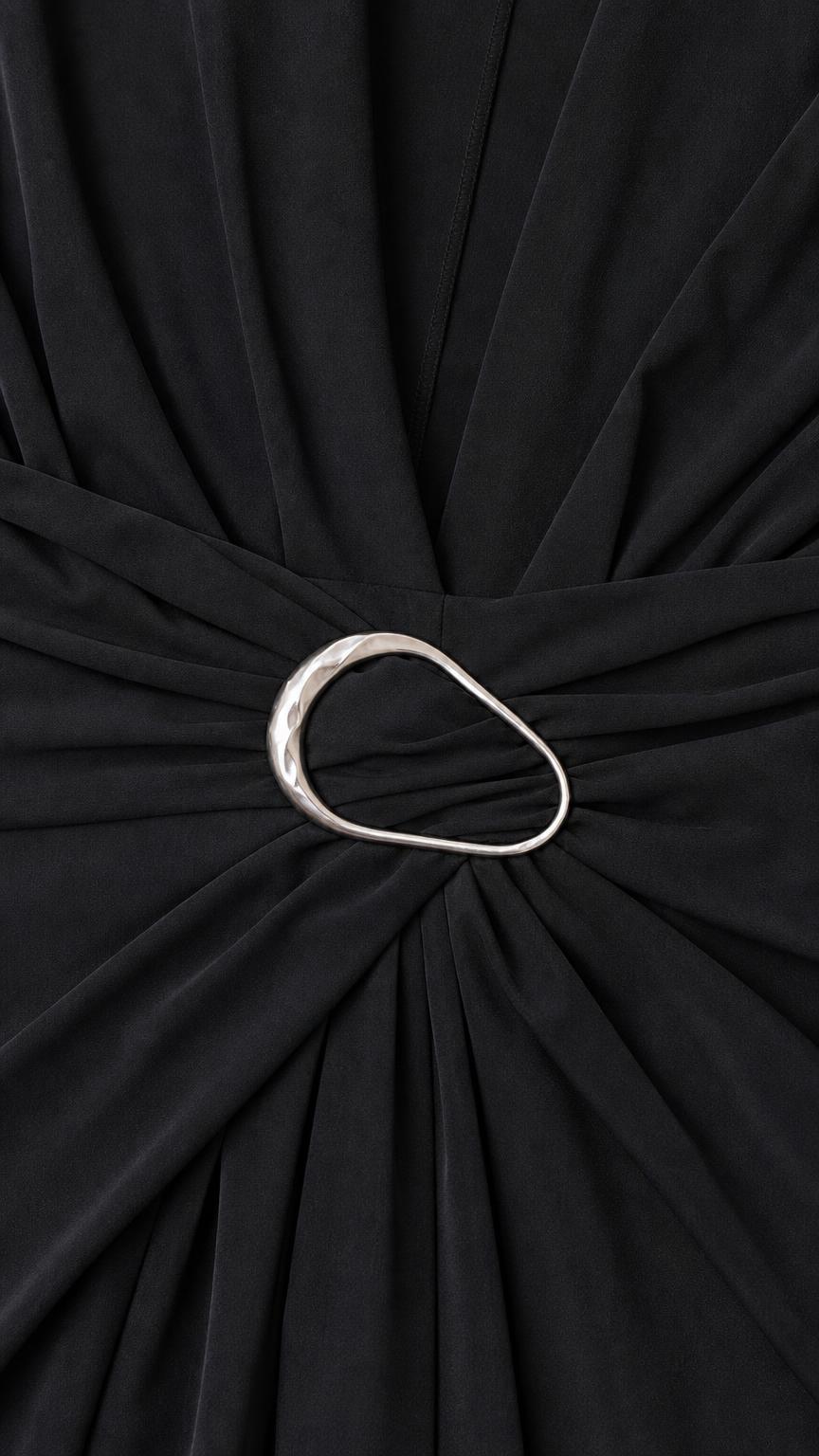 Close-up detail of metal ring waist accent on black dress