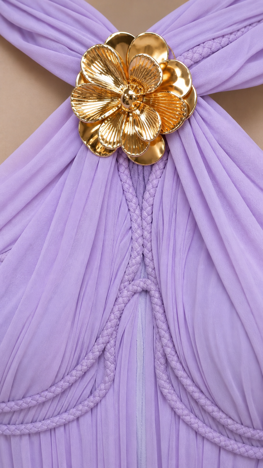Close-up of gold metallic floral accent on lavender dress