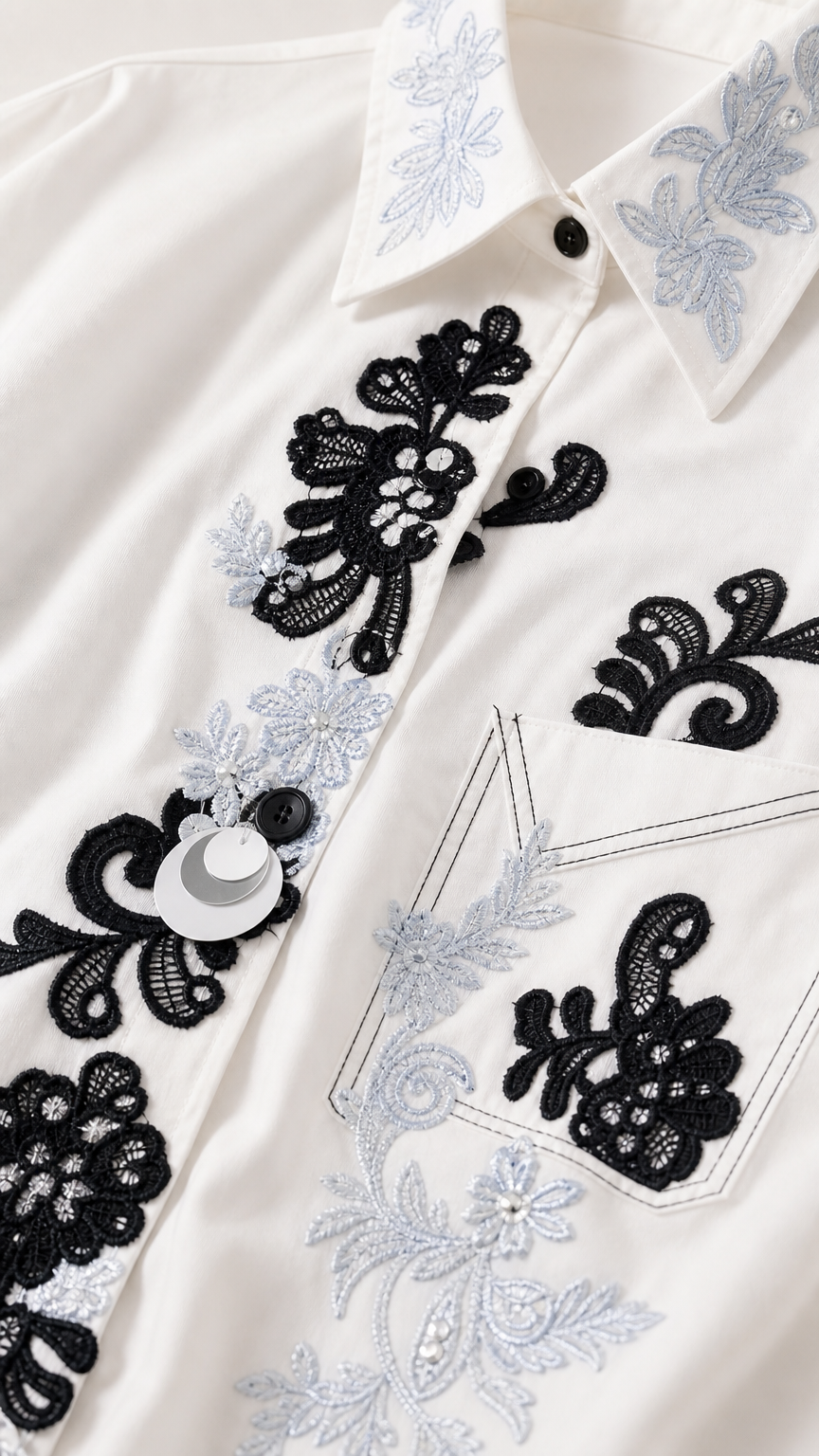 Close-up detail of floral embroidery and buttons on shirt collar