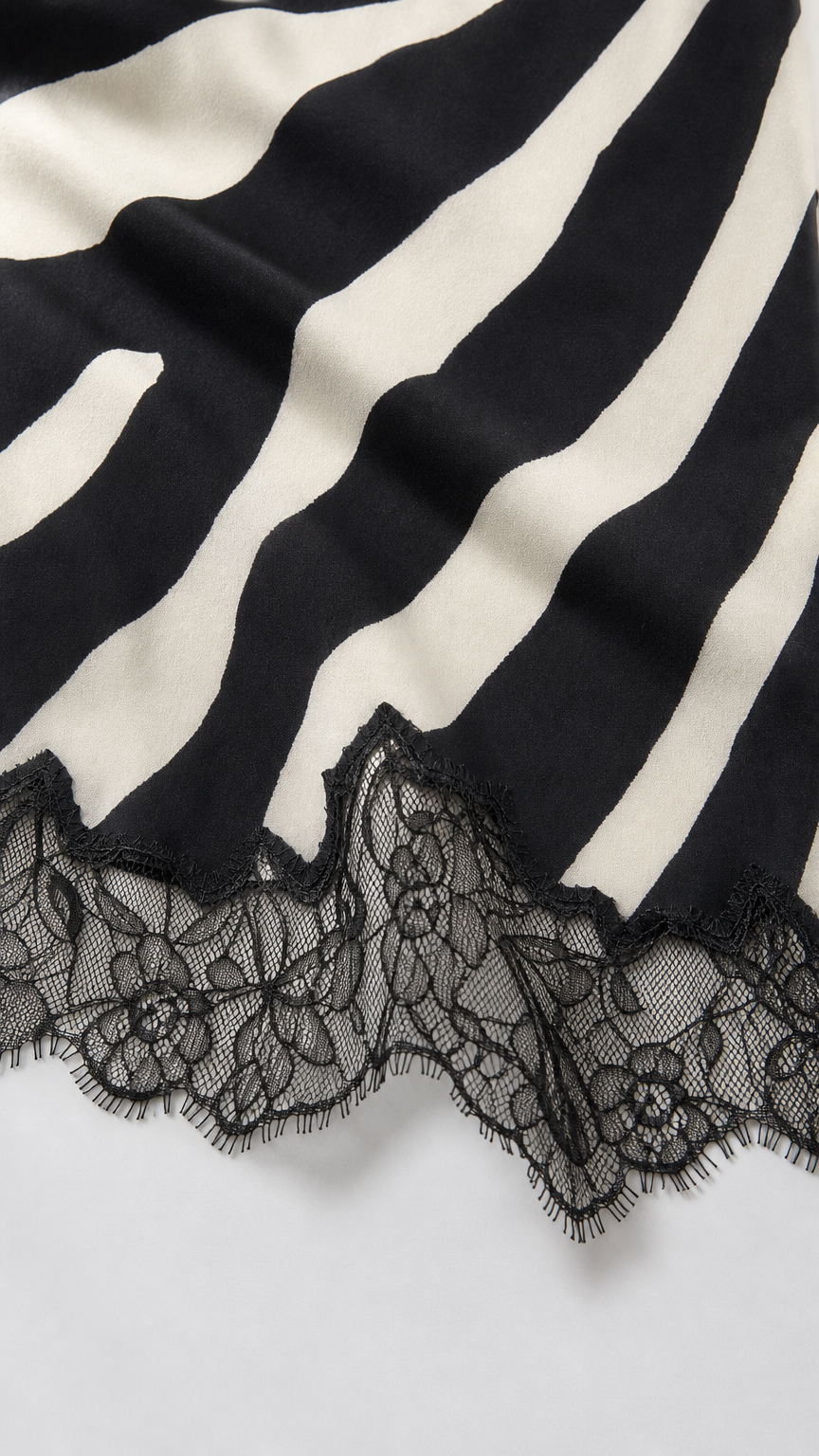 Close-up of the black and white zebra stripe fabric and scalloped lace hem