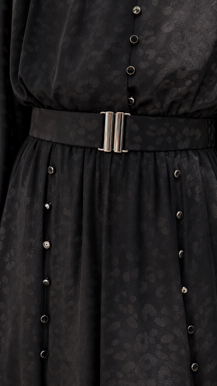 Close-up of black dress belt and button details