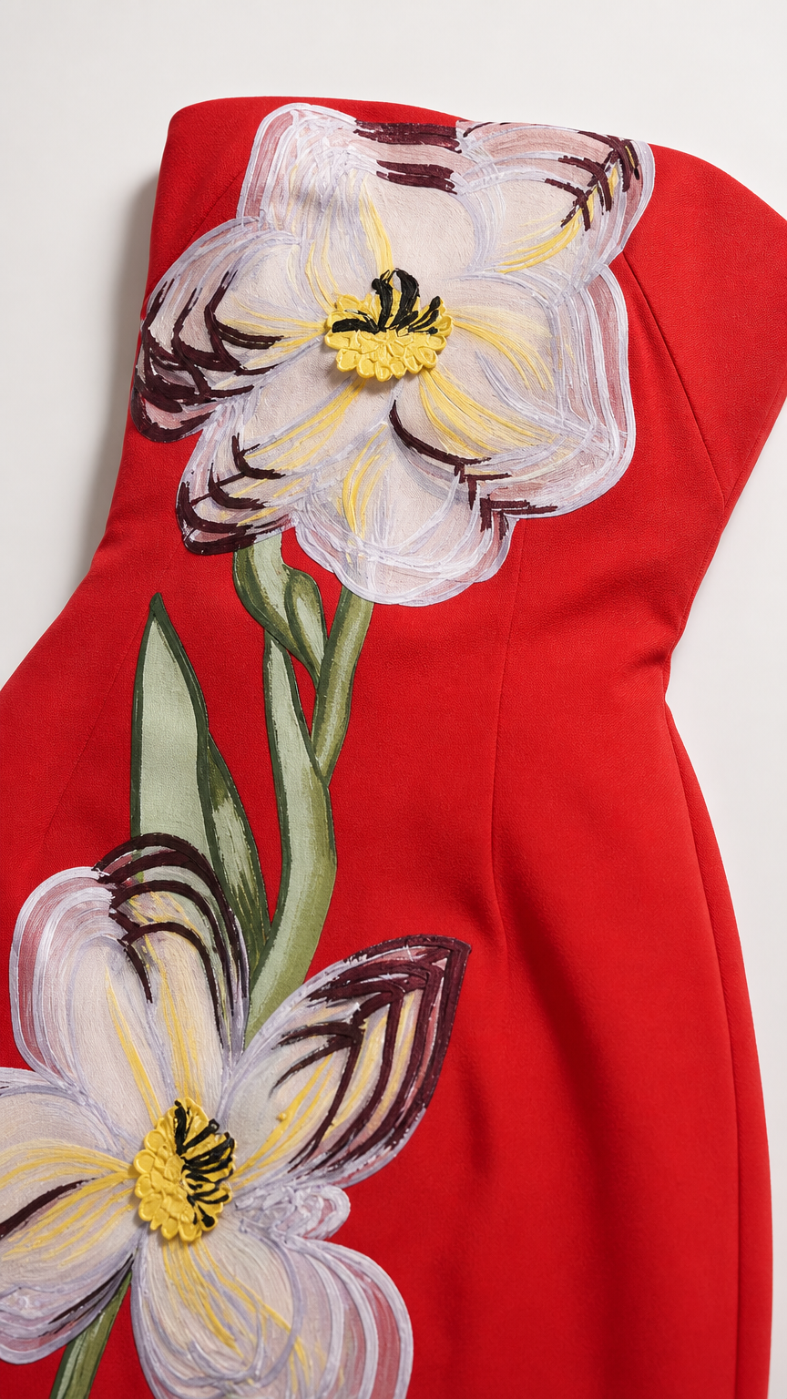 Close-up detail of floral applique on red dress