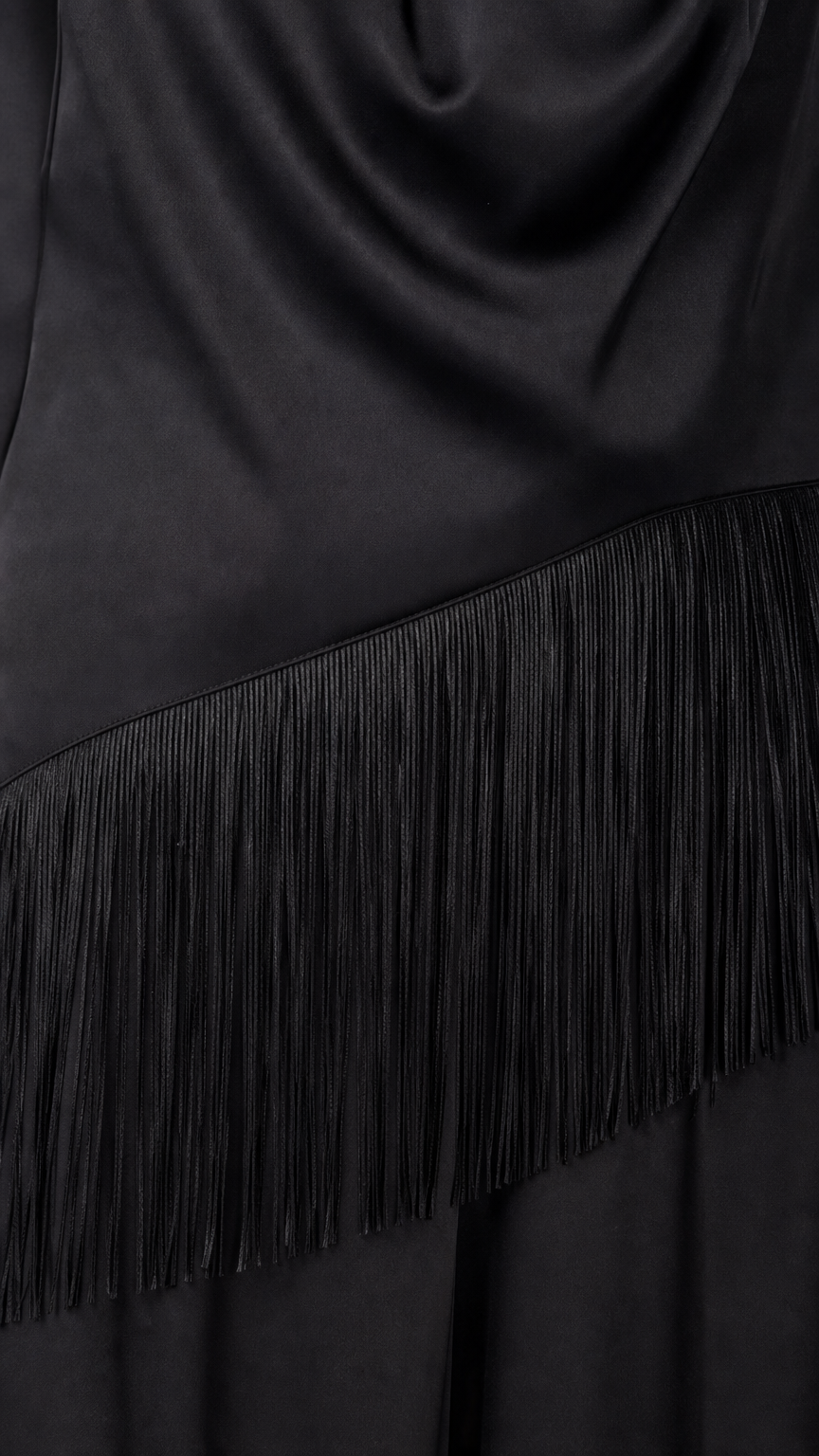 Close-up detail of fringe trim on black satin jumpsuit