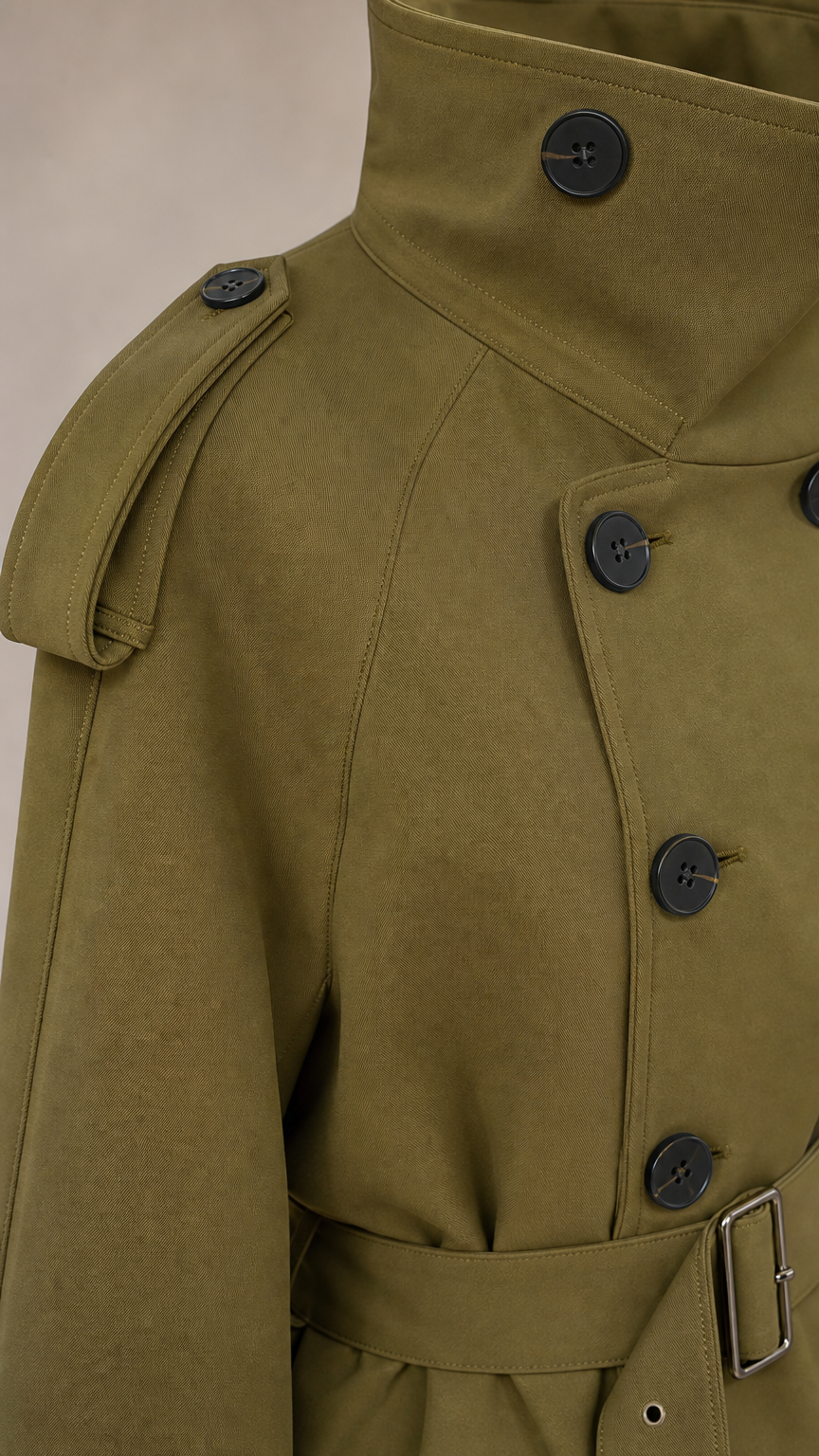 Close-up detail of khaki trench jacket collar, buttons, and epaulets