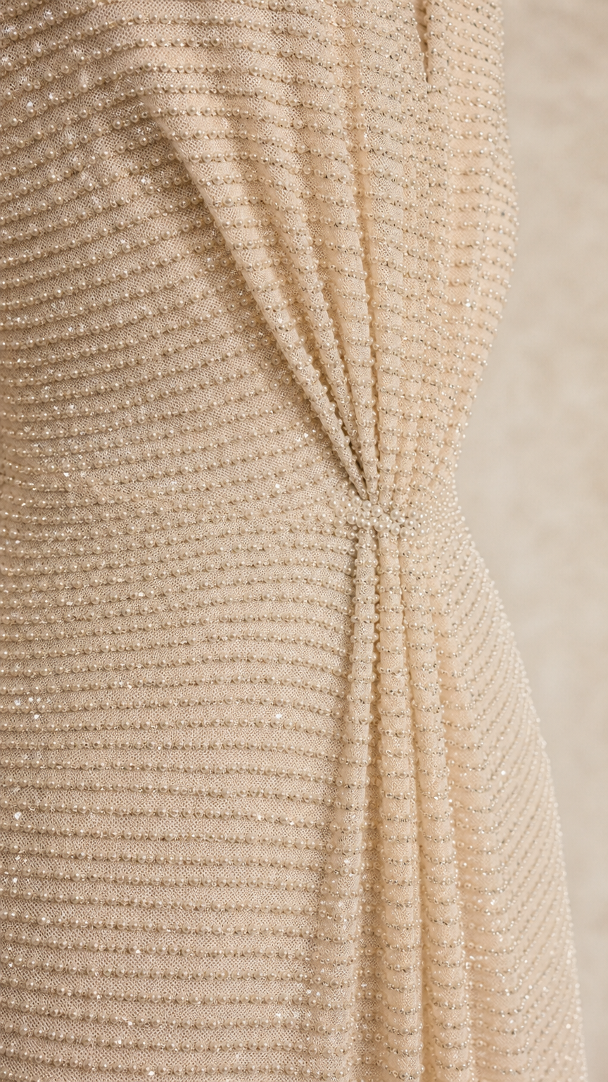 Close-up detail of textured fabric and front knot on champagne dress