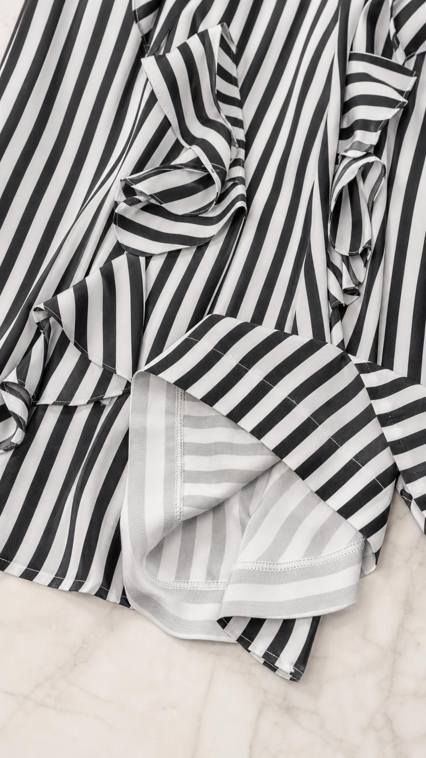 Close-up detail of fabric, ruffles, and stripes